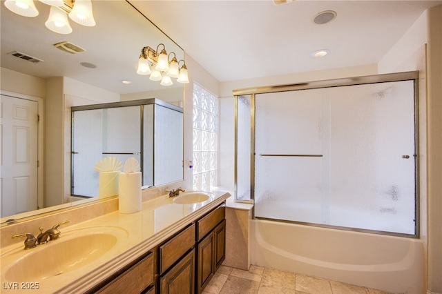 bathroom featuring double vanity, visible vents, a notable chandelier, and a sink