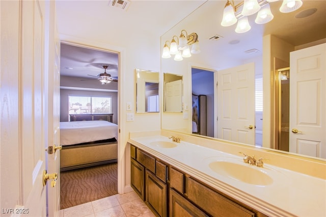 bathroom featuring a sink, connected bathroom, visible vents, and tile patterned floors