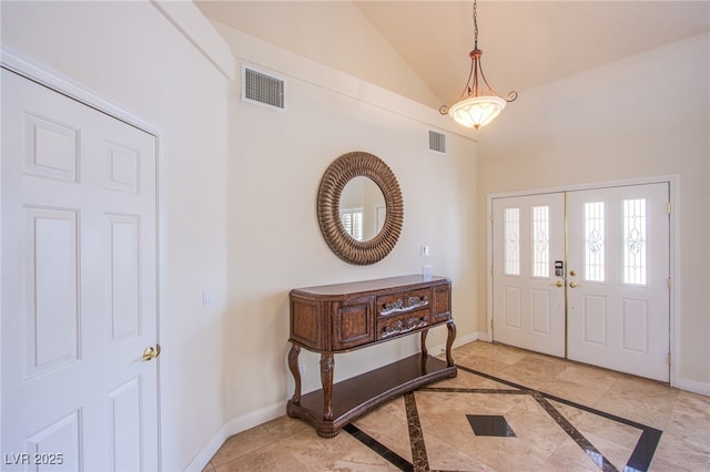 foyer entrance with visible vents and baseboards