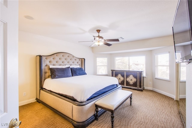 bedroom with visible vents, a ceiling fan, baseboards, and light carpet