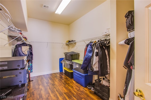 walk in closet featuring wood finished floors and visible vents