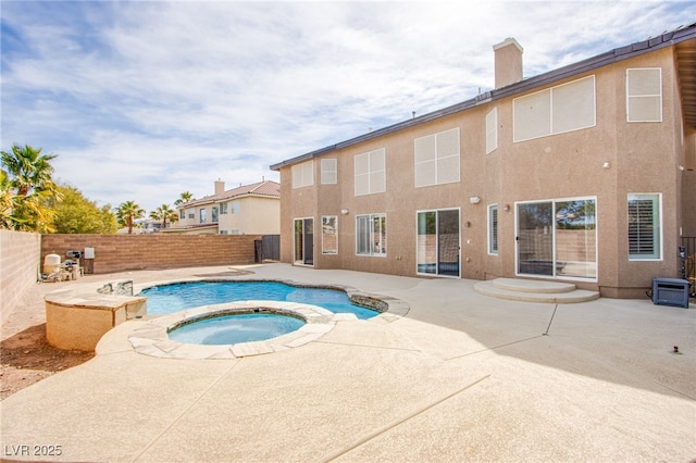 view of pool with a patio area, an in ground hot tub, and a fenced backyard