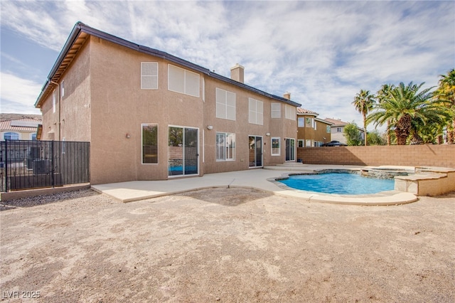 view of pool with a patio, a fenced backyard, and a pool with connected hot tub