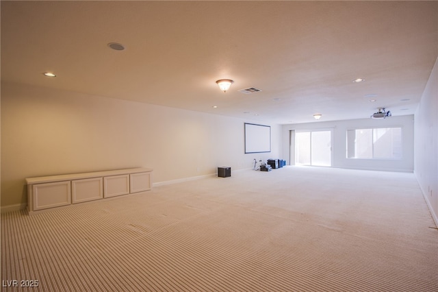 carpeted empty room featuring visible vents, recessed lighting, and baseboards