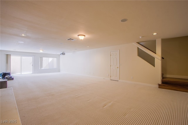 basement with stairs, recessed lighting, baseboards, and light carpet