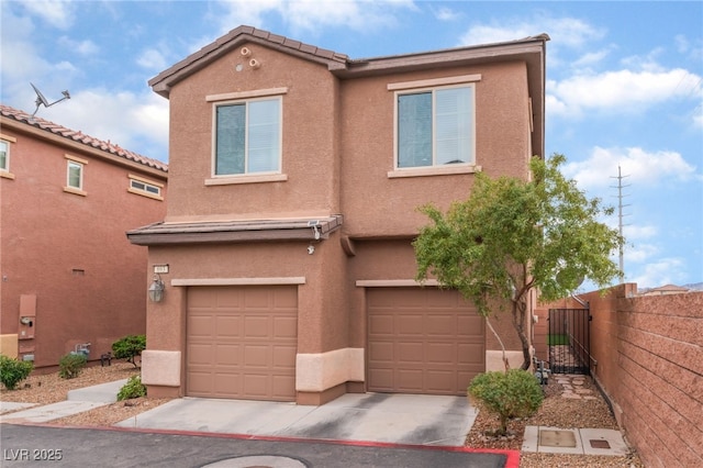 multi unit property featuring driveway, fence, and stucco siding