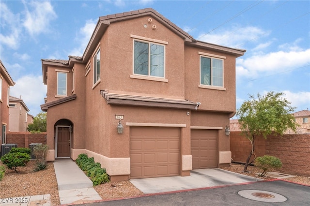 view of front of home with a tile roof, stucco siding, central AC, fence, and a garage