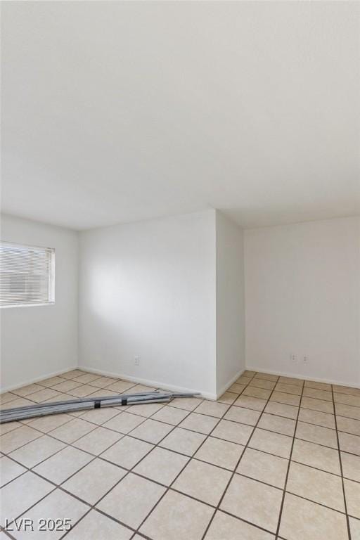 spare room featuring light tile patterned floors