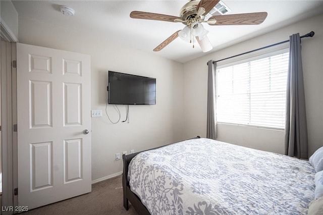 carpeted bedroom with baseboards and a ceiling fan