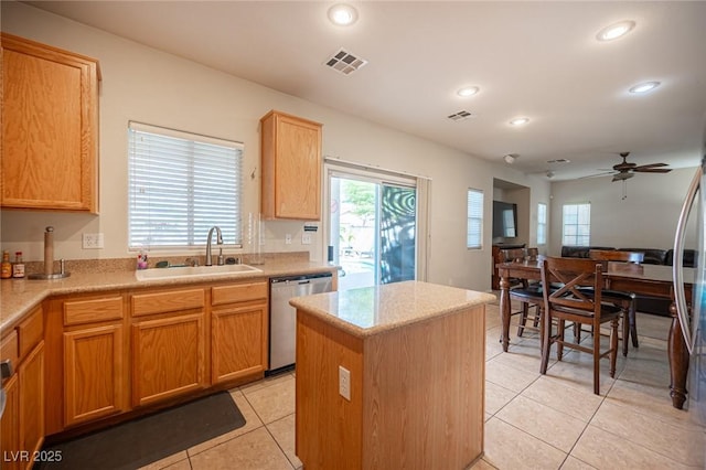 kitchen with light tile patterned floors, dishwasher, a center island, a sink, and recessed lighting