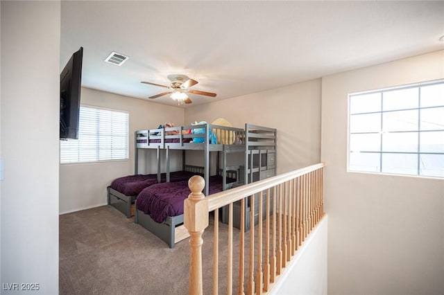 bedroom featuring carpet floors, visible vents, and a ceiling fan