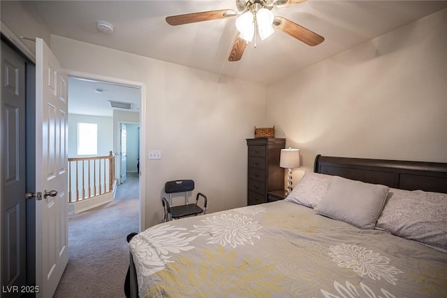 bedroom with carpet floors, visible vents, and a ceiling fan