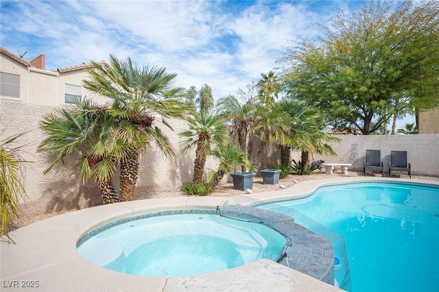 view of swimming pool with a pool with connected hot tub and a fenced backyard