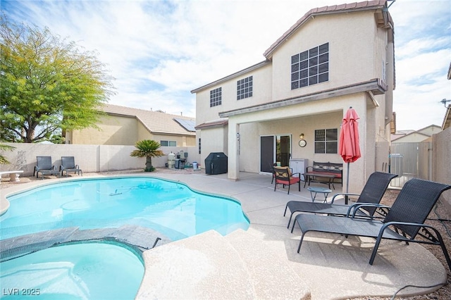 view of swimming pool featuring a patio, grilling area, a fenced backyard, and a pool with connected hot tub