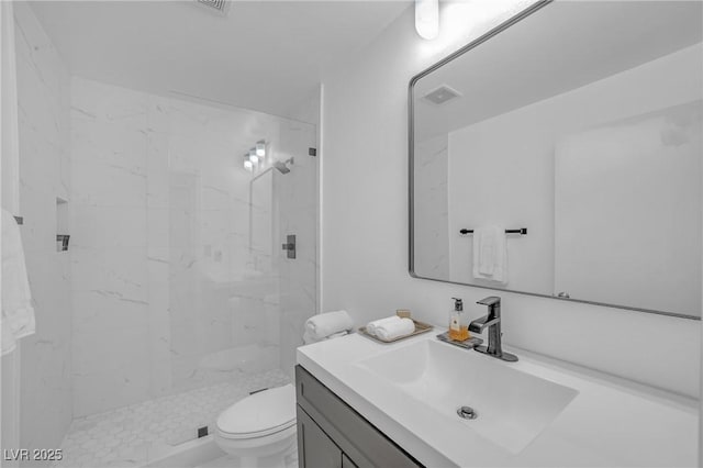 full bath with toilet, a marble finish shower, visible vents, and vanity