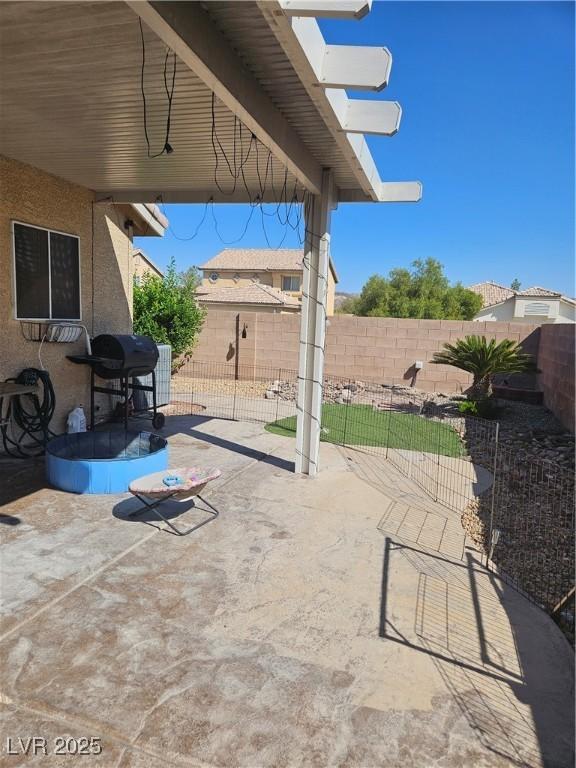 view of patio featuring an outbuilding and a fenced backyard