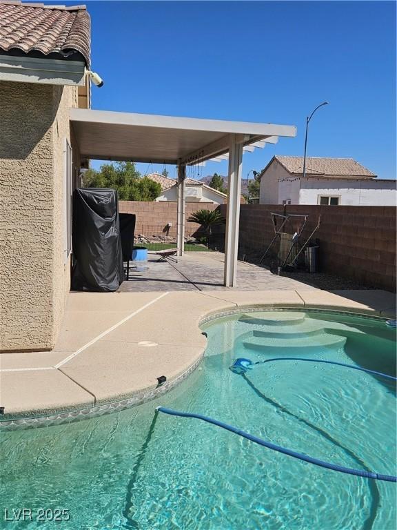 view of pool with a patio area, a fenced backyard, and a fenced in pool