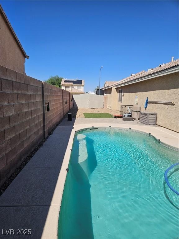 view of swimming pool with a fenced in pool and a fenced backyard