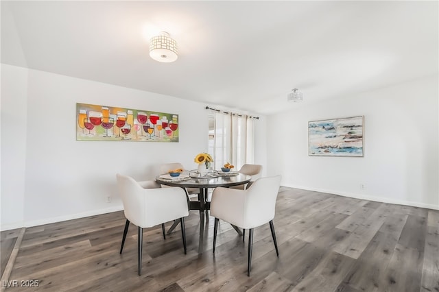 dining room featuring baseboards and wood finished floors