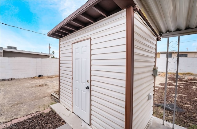 view of outbuilding with a fenced backyard and an outdoor structure