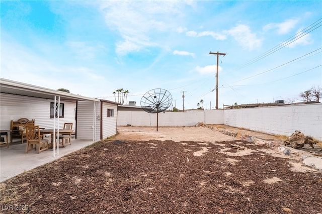 view of yard featuring a patio area and fence