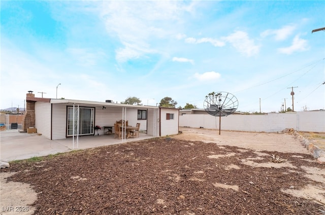 rear view of property with a patio area and fence