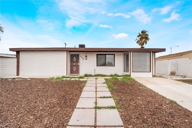 ranch-style house with fence