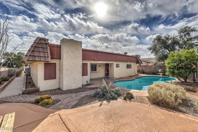 view of pool featuring fence, a fenced in pool, and a patio