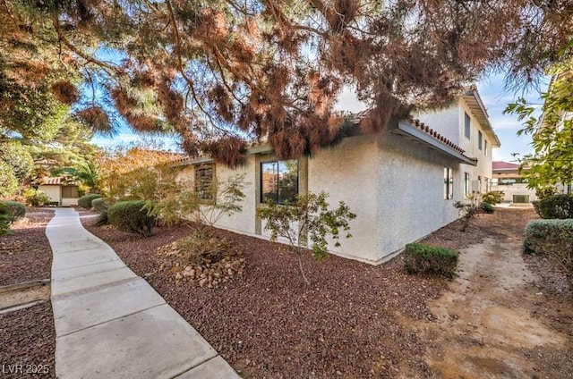 view of side of property featuring stucco siding