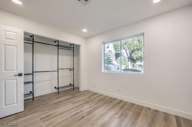 unfurnished bedroom with light wood-type flooring, visible vents, baseboards, and recessed lighting