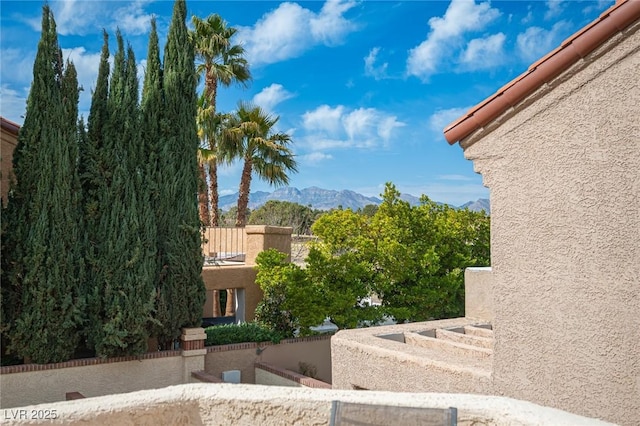 view of yard with a balcony and a mountain view