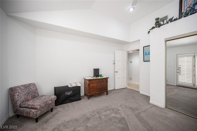 living area with carpet, lofted ceiling, and baseboards