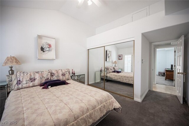 carpeted bedroom featuring lofted ceiling, ceiling fan, a closet, and baseboards