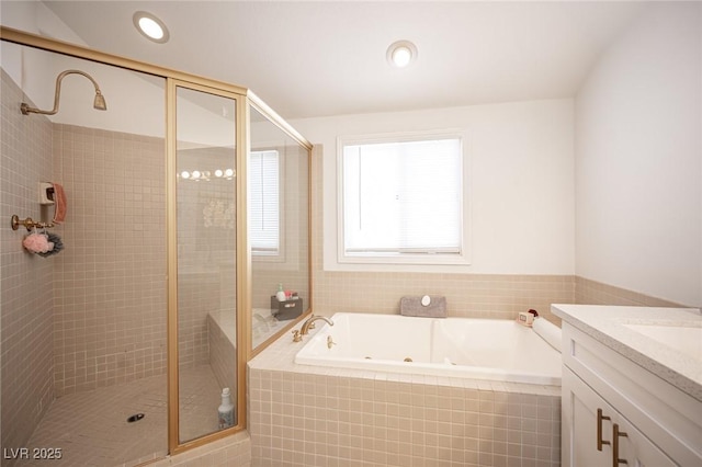 bathroom featuring a whirlpool tub, a stall shower, vanity, and recessed lighting