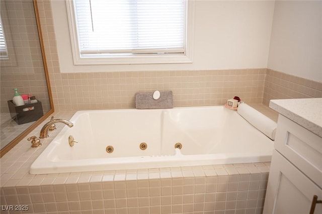 bathroom with a jetted tub and vanity