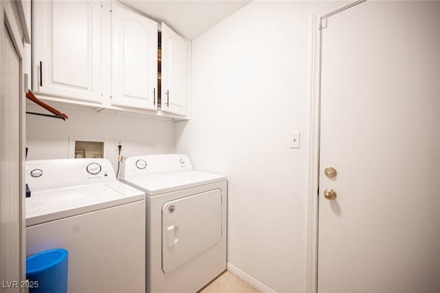 laundry room with cabinet space, baseboards, and separate washer and dryer