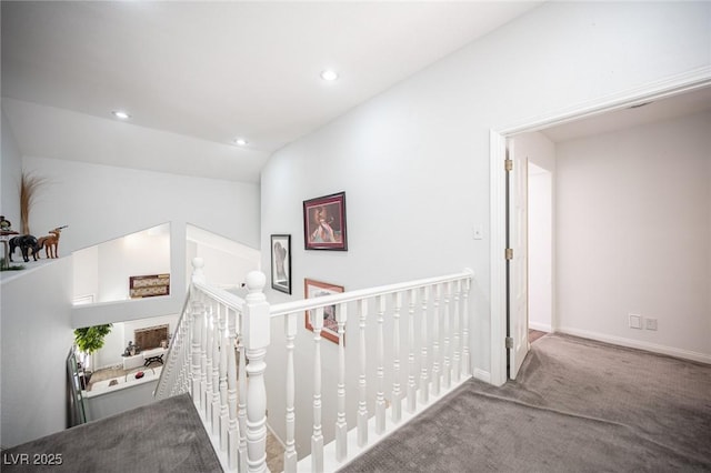 hallway featuring lofted ceiling, carpet flooring, an upstairs landing, and recessed lighting