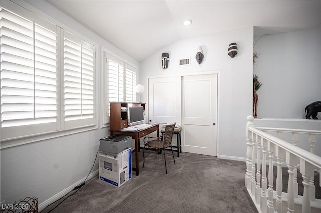 carpeted office space with visible vents, baseboards, and vaulted ceiling