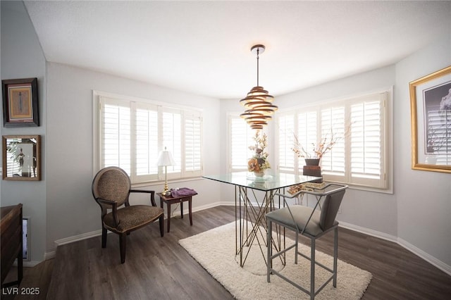 dining room with dark wood-style flooring, plenty of natural light, and baseboards