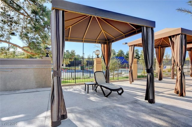 exterior space with a gazebo and fence