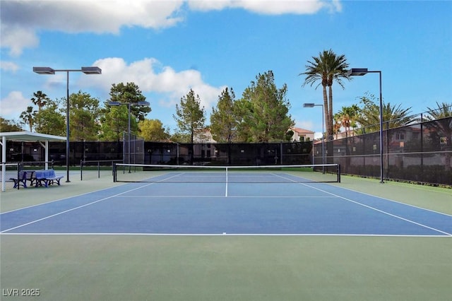 view of tennis court featuring fence