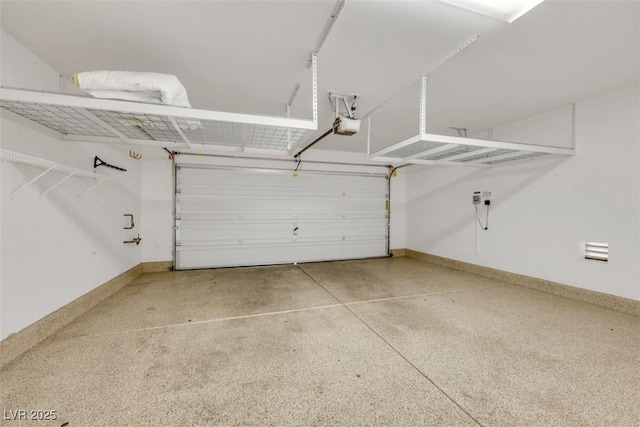 garage featuring baseboards and a garage door opener