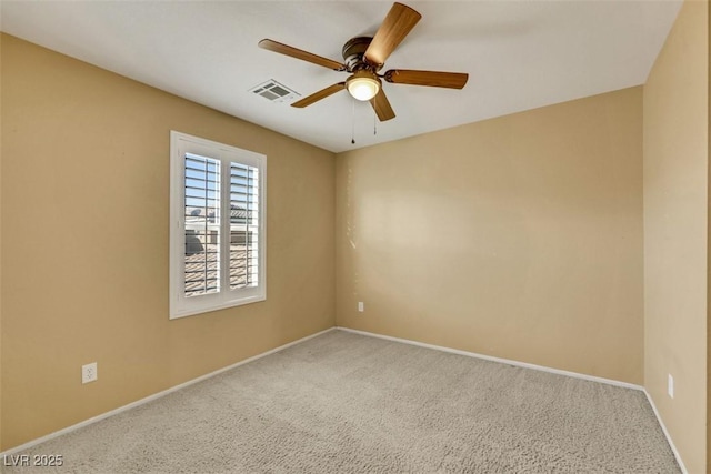 empty room featuring baseboards, ceiling fan, visible vents, and carpet flooring