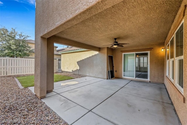 view of patio featuring ceiling fan and fence