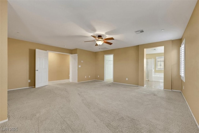 unfurnished room with light carpet, ceiling fan, visible vents, and baseboards