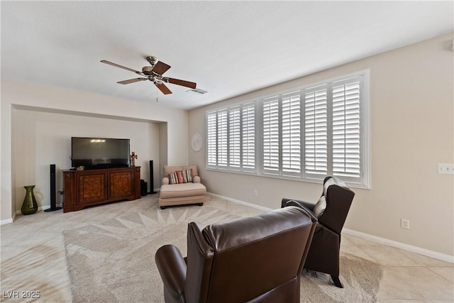 living room with visible vents, ceiling fan, baseboards, and light tile patterned flooring