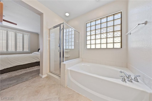 ensuite bathroom featuring a stall shower, connected bathroom, a bath, and tile patterned floors