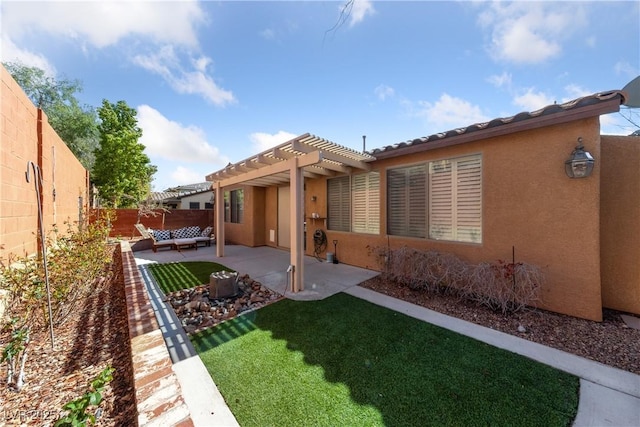 back of property featuring a fenced backyard, a lawn, stucco siding, a pergola, and a patio area