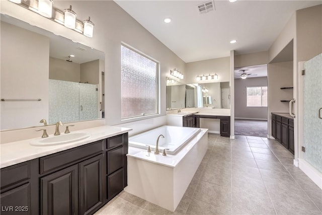 full bathroom with visible vents, a ceiling fan, a stall shower, a sink, and tile patterned flooring