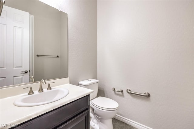 bathroom featuring toilet and vanity